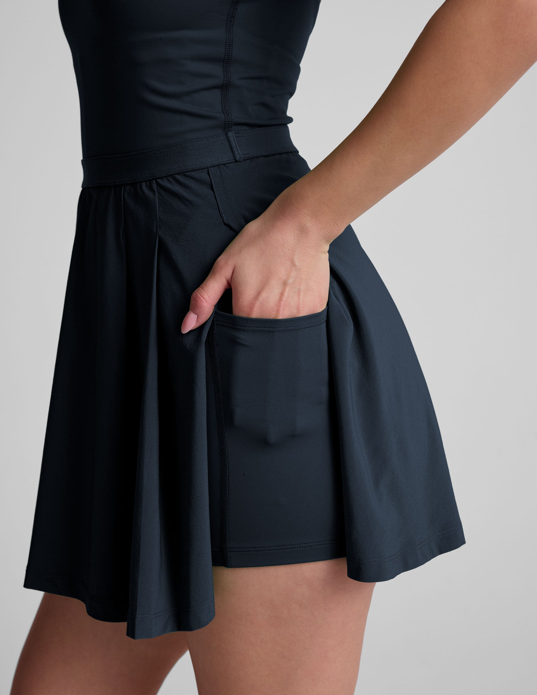 Active Pleated Mini Dress: Built-in Shorts, Pockets, Open Back Design