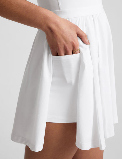 Score Active Pleated Mini Dress: Built-in Shorts, Pockets, Open Back